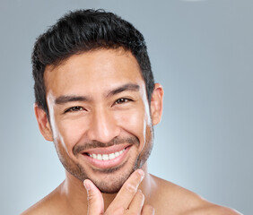 Grooming, portrait and skincare with masculine man in studio on gray background for cosmetic...