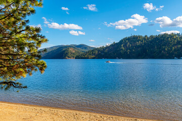 A boat passes in front of a small sandy beach at Beacon Point, a stop on the Centennial Trail, on...