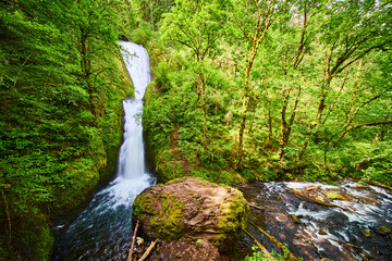 Bridal Veil Falls Cascading into River Surrounded by Lush Forest - Elevated View