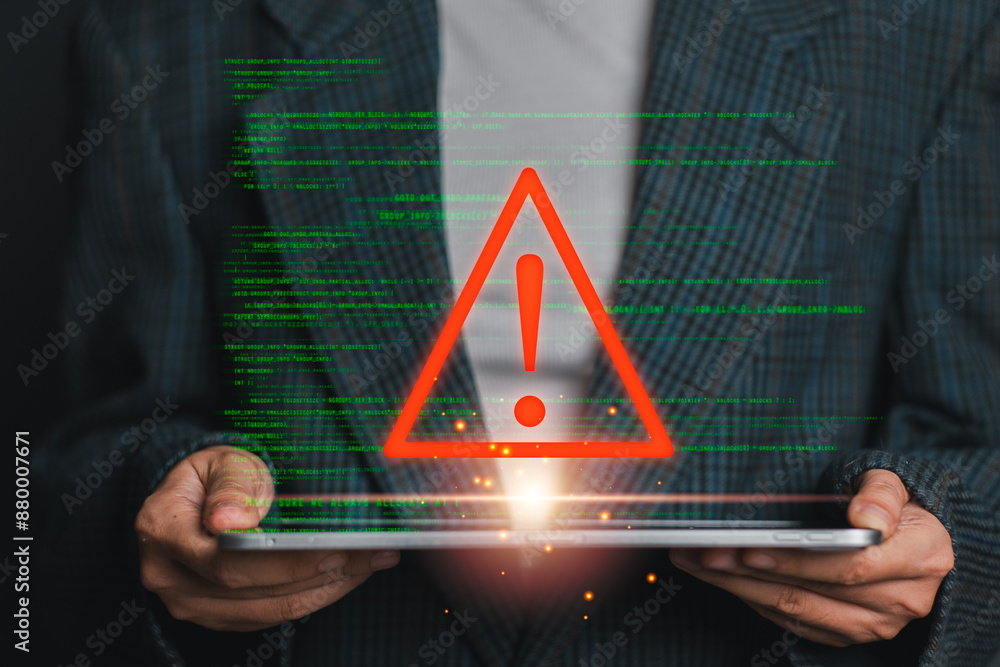 Poster a person holding a tablet with a red warning symbol and green code lines, symbolizing a data breach 