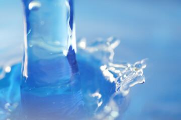 Macro shot of water splashing on blue background