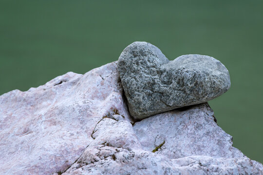 Stone in the shape of a heart lies in the notch of another stone, Tiefenbachklamm, Kramsach, Tyrol, Austria, Europe