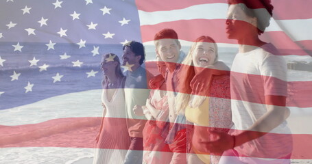 Image of flag of usa over happy diverse friends on beach in summer