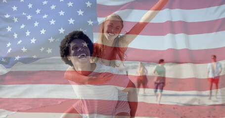 Image of flag of usa over diverse friends walking on beach