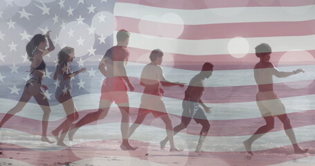 Image of flag of usa over happy diverse friends on beach in summer