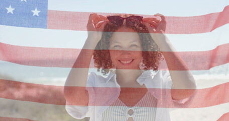 Image of flag of usa over happy diverse friends on beach in summer