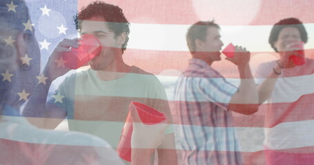 Image of flag of usa over happy diverse friends at beach party in summer