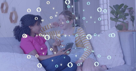 Image of icons and data processing over diverse women using smartphone