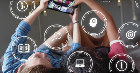 Image of icons and data processing over diverse women using smartphone