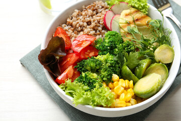 Healthy meal. Tasty products in bowl on white table, closeup