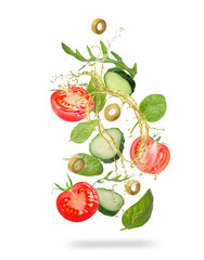 Fresh vegetables and oil for salad in air on white background