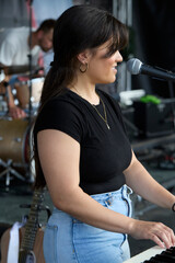 Female performer on stage. Portrait of woman at a microphone.