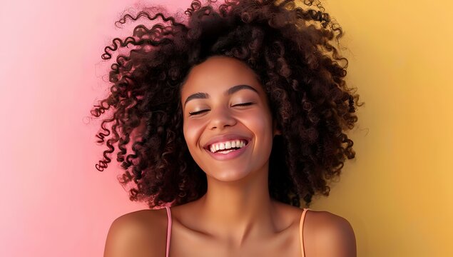 Smiling woman with curly hair against a vibrant, colorful background, exuding joy and positivity, ideal for lifestyle, wellness, and happiness themes.