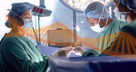 Image of dna strand over diverse surgeons in hospital