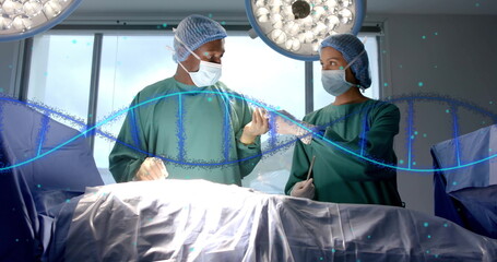 Image of dna strand over diverse surgeons in hospital