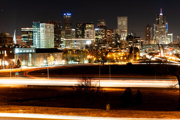 Fototapeta premium City lights and traffic trails illuminate the urban night