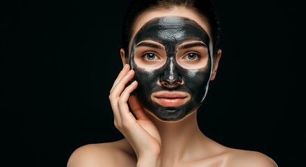 Woman with charcoal face mask. Skin care concept.