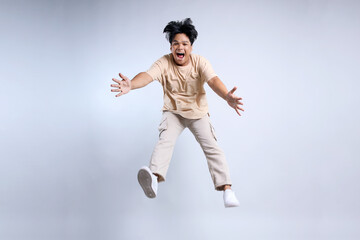 Full Length Of Jumping Young Asian Man With Casual Style Isolated On White Background