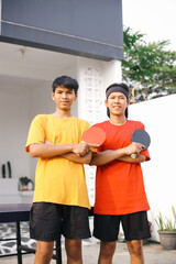 Confident Young Asian Man Sportswear Crossed Arms Before Playing Ping Pong Together With Friend 