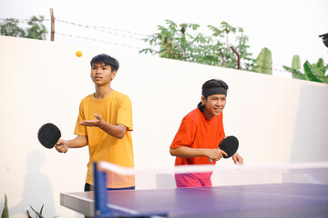 Focused Young Asian Sportsman Take A Service Before Playing Ping Pong Together With Friend 