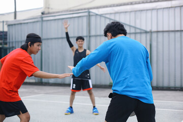 Asian Men Playing Basketball in a Court