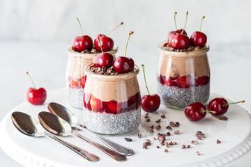 Black forest chia puddings topped with fresh cherries and cacao nibs.