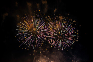 Montreal, Canada - June 27 2024: Fire works show with quarter moon in background at La Ronde in Montreal