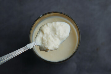 glass of whole cream milk on table , Cream of milk.