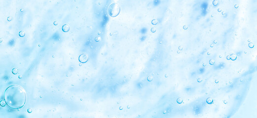 Cosmetic gel, serum transparent sample. Liquid cream with bubble texture. Gel texture of a cosmetic product. Clear liquid lotion for skin care.