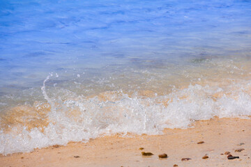 View of background for summer vacation concept. Nature of the beach and sea, summer with sunlight, sandy beach The sparkling sea water