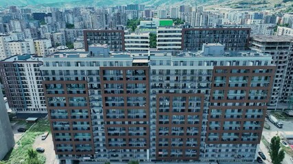 Aerial view of a city block with high-rise apartment buildings, showcasing the density and architectural style of urban living