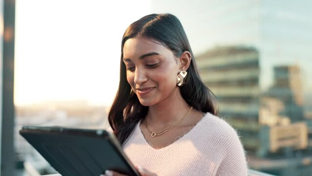 Balcony, business woman and tablet for typing, research and online results with smile. Professional, career and Indian editor with digital for scroll article, blog post and info with pride in rooftop