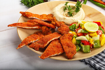 Slices pork schnitzel with vegetables