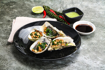 Open half oysters with green onion