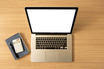 laptop computer with blank white desktop screen on the desk with clipping paths. top view,above view.