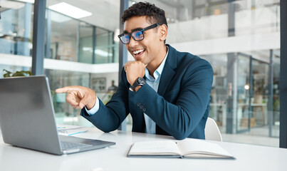 Happy, businessman and pointing with laptop for video call, meeting or reading proposal at office desk. Excited man or young employee with smile on computer for email or communication at workplace