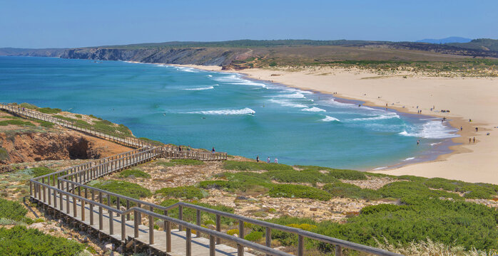 Scenic view Praia de Bordeira (Bordeira beach), beautiful beach and wooden foothpath going  to the seaside  Algarve, Portugal