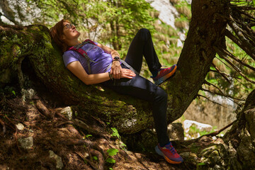 Woman hiker with backpack in the mountains