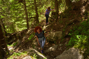 Fototapeta premium Women with backpacks hiking in the mountains