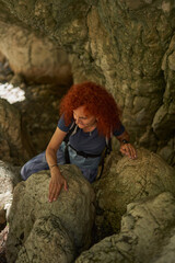 Woman hiker with backpack in the mountains
