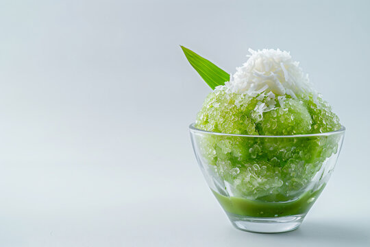 a green dessert with a leaf in a glass bowl