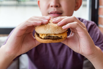 person eating hamburger