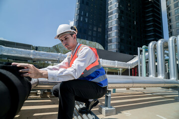 Male engineer inspects air and water pipelines in the engineering system area of ​​the factory...