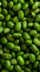 A close-up image of fresh green soybeans tightly packed together, displaying their glossy, smooth surfaces and vibrant color, ideal for concepts of freshness and nutrition.