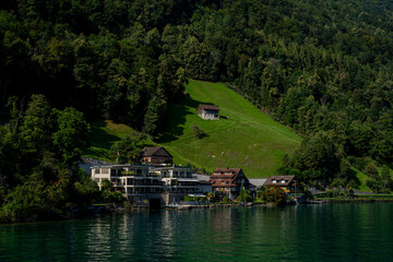 Fototapeta premium Switzerland landscape. Village on Lake in Switzerland. Mountain scenery in the Alps . Switzerland Alps. Landscape of touristic alpine village. Switzerland Mountain panorama.