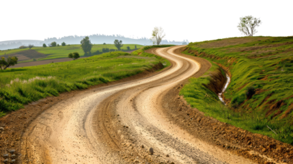 Winding dirt road through green countryside, bordered by fields and trees, leading into hills under a clear sky.