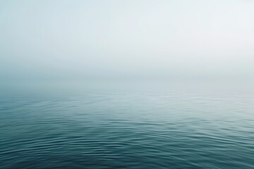 Obraz premium Misty sea horizon blends sky and water in tranquil softness