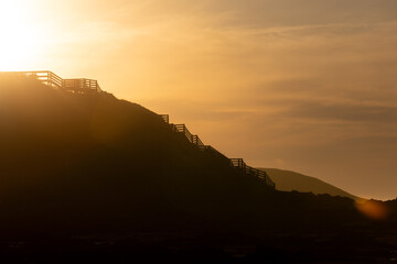 Silhouette coastal steps on hill at sunrise golden hour Phillip Island