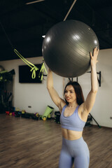 Fototapeta premium Fit girl workout with fitness ball in plank position in gym.