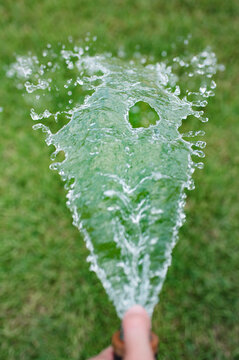 Water from a water hose on a hot summer day